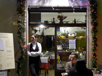 Woman looking at illuminated store