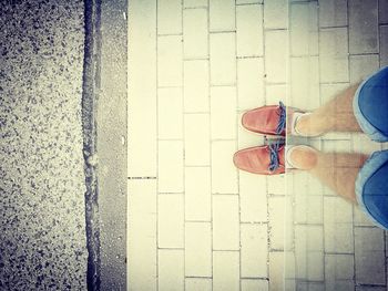 Low section of man standing on road