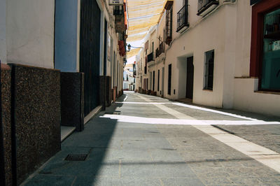 Empty alley along buildings