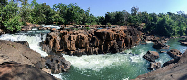 Panoramic shot of rocks in sea against sky