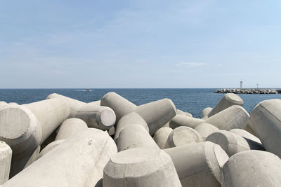 Close-up of groyne in sea against sky