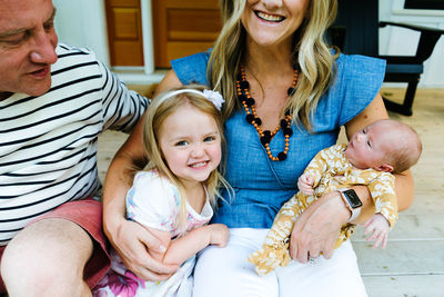 Cropped portrait of a family embraced and laughing together
