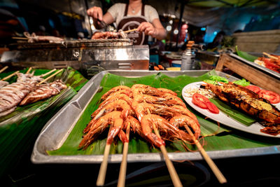 Meat on barbecue grill at market stall