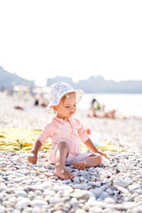 Portrait of young woman standing at beach
