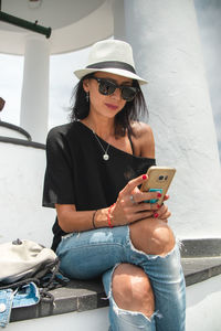 Smiling woman using mobile phone outdoors