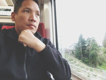 Portrait of young man in train