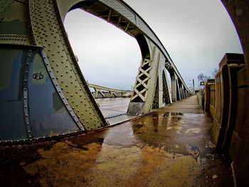 Bridge over river against sky during rainy season