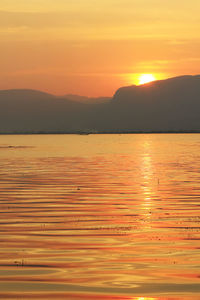 Scenic view of sea against romantic sky at sunset