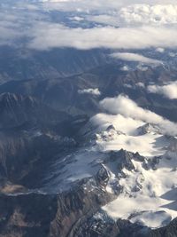 Aerial view of snowcapped mountains against sky