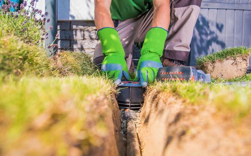 Low section of man working on field