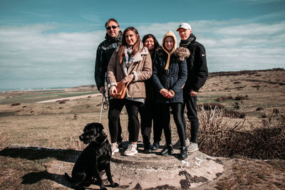 Family and dog on land