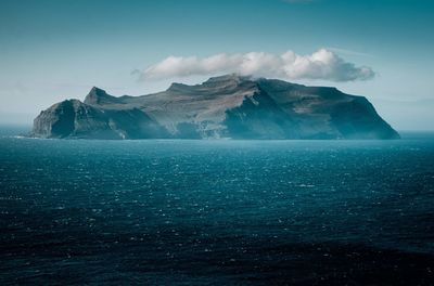 Scenic view of sea and mountains against sky