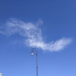 Low angle view of street light against blue sky