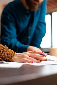 Midsection of business people working at office