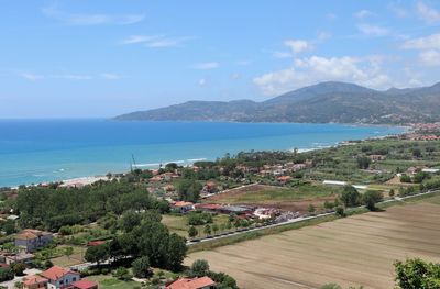 High angle view of sea and mountains against sky