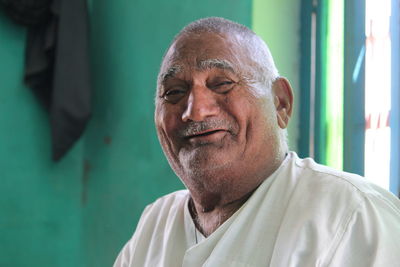 Close-up portrait of senior man smiling at home