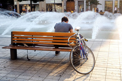 Rear view of man cycling in city