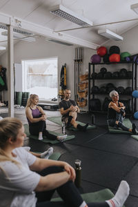 Man and women stretching during fitness class