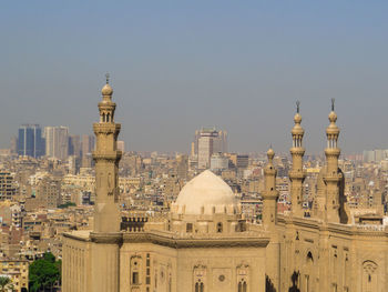 Buildings in city against clear sky