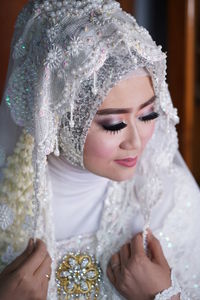 Portrait of smiling young woman in warm clothing