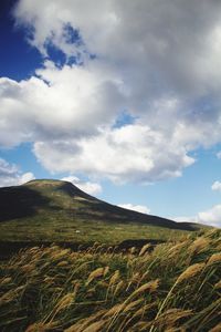 Scenic view of mountains against cloudy sky