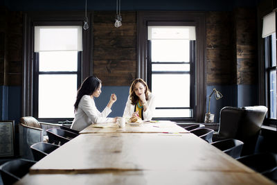 Woman sitting on table