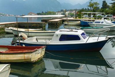 Mooring boats and boats against a background of mountains and houses with red roofs