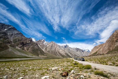 Scenic view of snowcapped mountains against blue sky