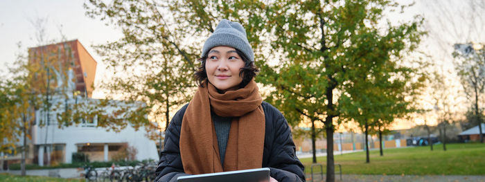 Portrait of young woman using mobile phone