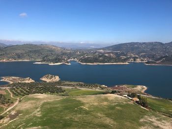 Scenic view of bay against clear blue sky