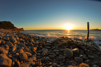 Scenic view of sea against clear sky during sunset