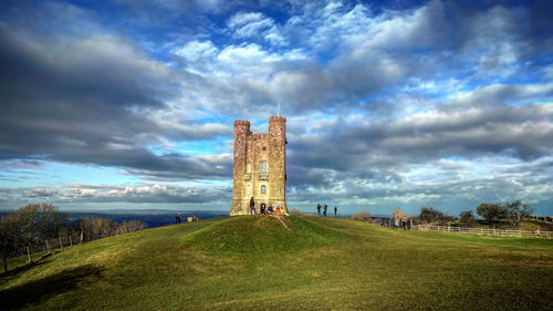 Tower on field against sky