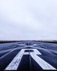 Road by landscape against sky