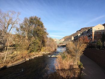 Arch bridge over river against sky