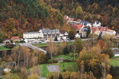 High angle view of houses amidst autumn trees