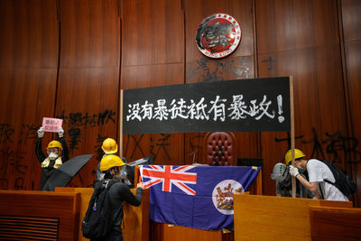 Rear view of people standing on table