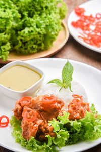 Deep fried chicken and green curry with rice , vegetable in white plate. thai food