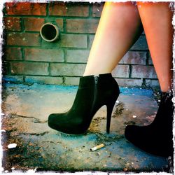 Low section of woman standing on tiled floor