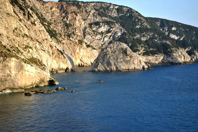 Scenic view of sea and mountains against sky