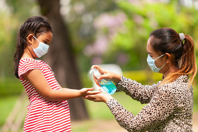 Girl applying sanitizer in hands