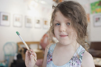 Portrait of cute girl holding camera