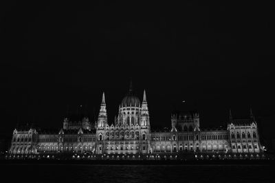 Illuminated city against sky at night