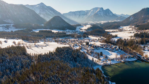 Panoramic view of lake by buildings against mountains