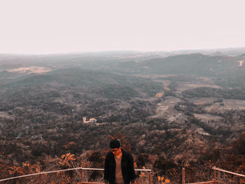 Man standing on mountain against sky