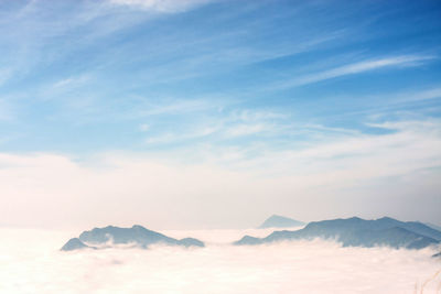 Scenic view of mountains against cloudy sky