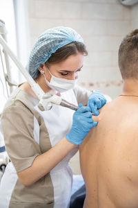 Side view of man with iv drip at home