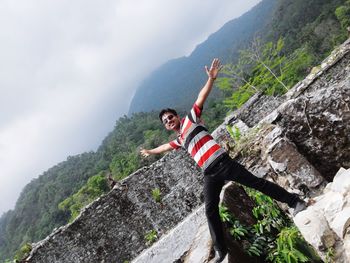 Full length of man on rock against mountains