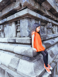 Woman sitting on staircase of prambanan 