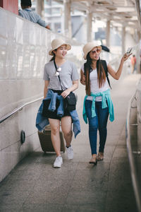 Tourists on footpath in city