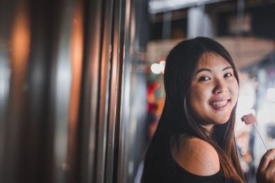 Portrait of smiling young woman having food